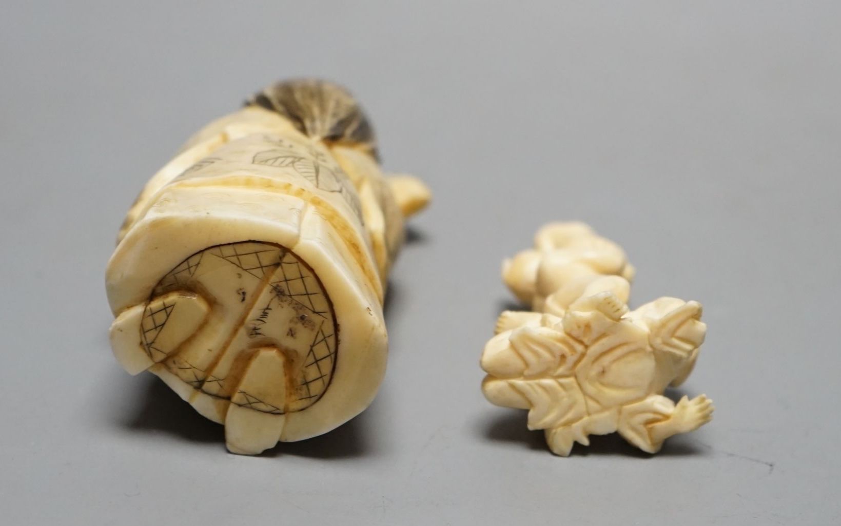 A Japanese face changer, early 20th century, a small okimono of acrobats, Meiji period and an ivory paper knife with lacquer decoration, face changer 8 cms high.